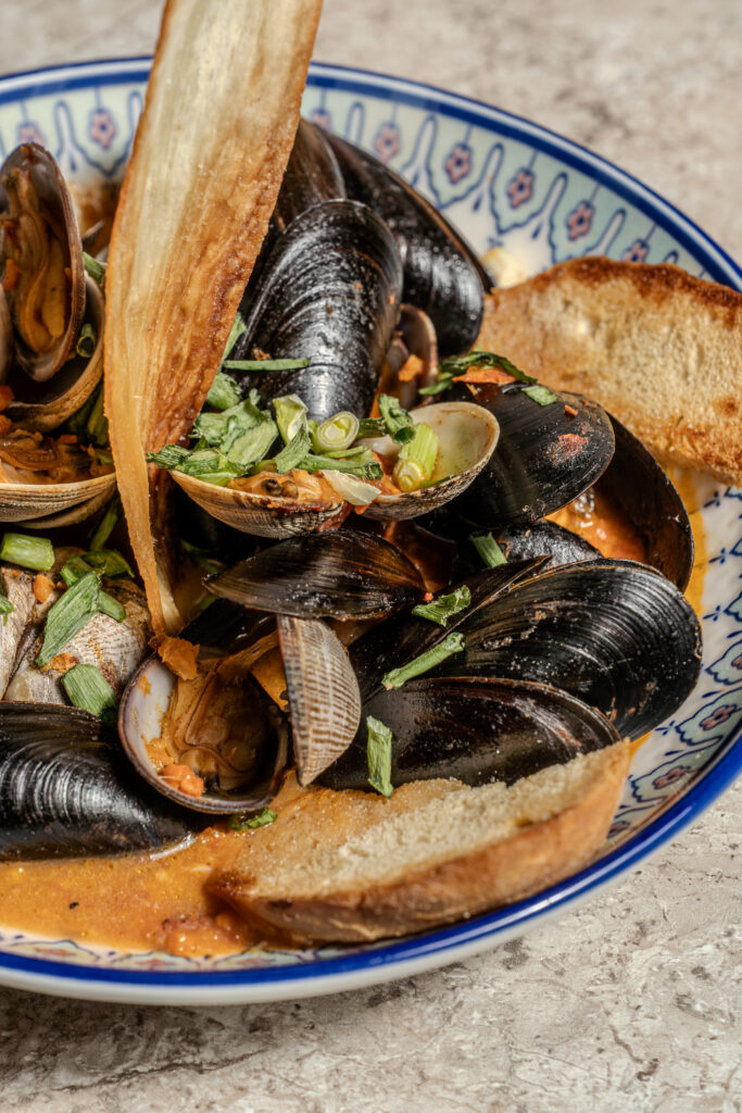 PEI mussels and Manila clams in white wine broth with crostini at Olivea Restaurant