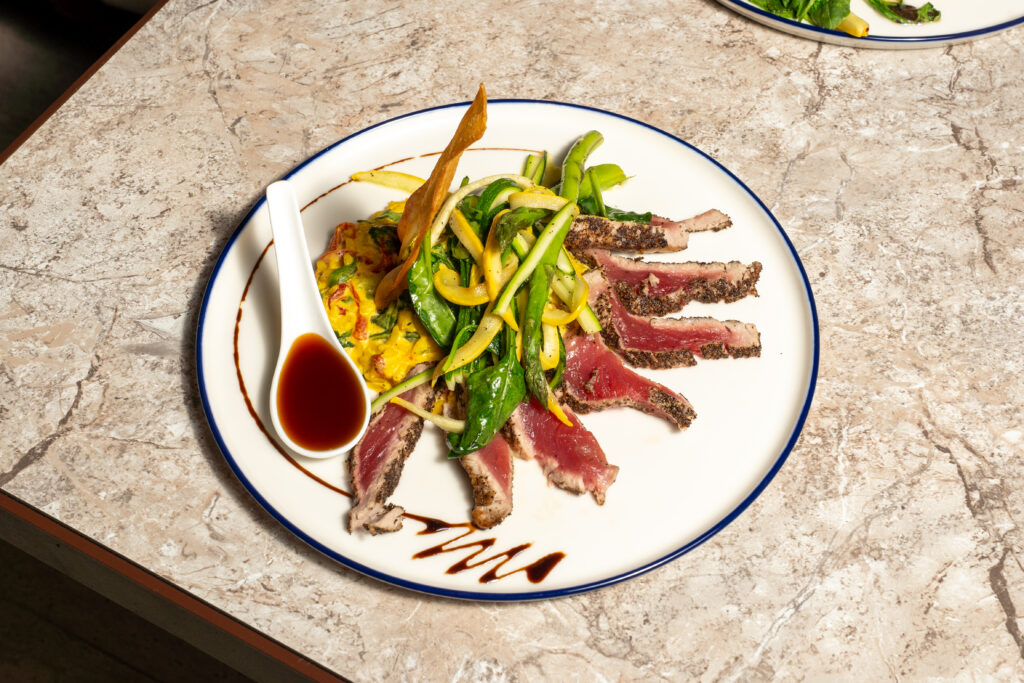 Pepper-crusted seared ahi tuna with green and yellow beans at Olivea Restaurant